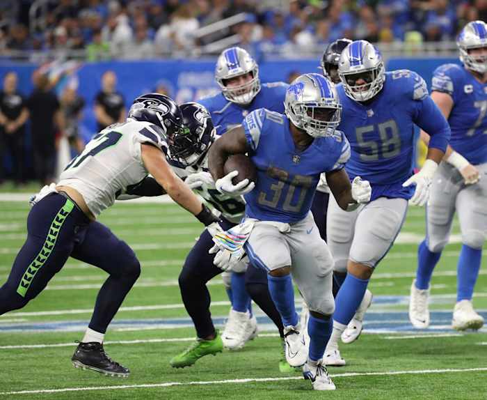 Detroit Lions running back Jamaal Williams runs past Seattle Seahawks defenders.